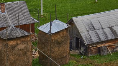 Picture of a stables with a big pile of hay which is a fire risk.